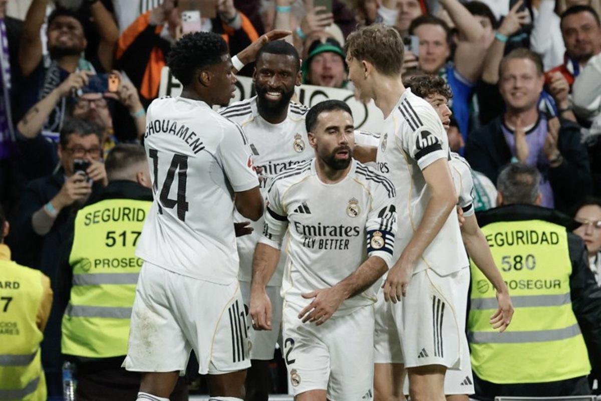 Real Madrid's German defender #22 Antonio Ruediger (2L) celebrates scoring his team's first goal during the Spanish league football match between Real Madrid CF and Elche CF at the Santiago Bernabeu Stadium in Madrid on March 14, 2026.  Oscar DEL POZO / AFP