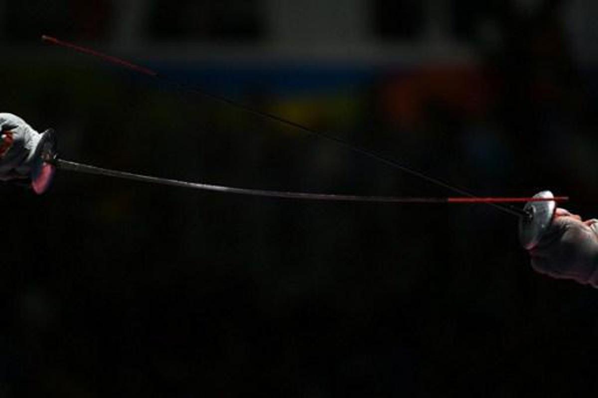 Russia's Timur Safin competes against China's Chen Haiwei during their men¿s individual foil quarter-final bout as part of the fencing event of the Rio 2016 Olympic Games, on August 7, 2016, at the Carioca Arena 3, in Rio de Janeiro. 
Kirill KUDRYAVTSEV / AFP