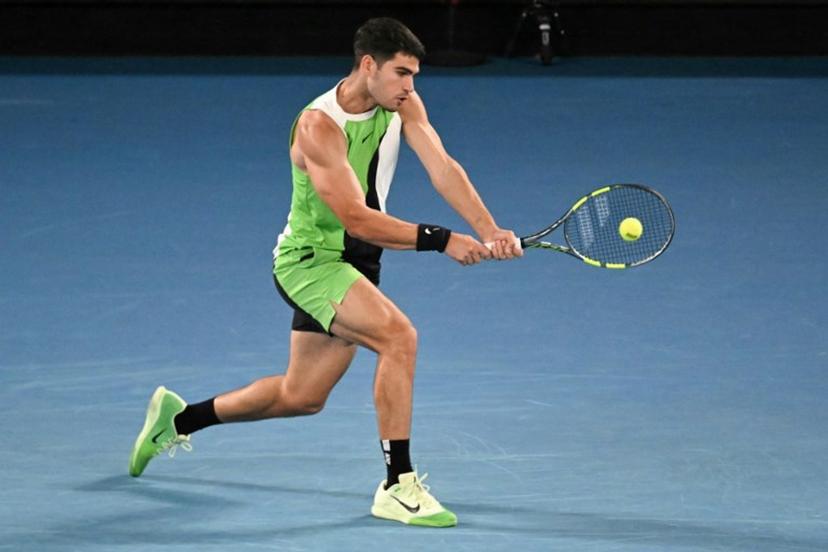 Spain's Carlos Alcaraz hits a return against Australia's Adam Walton during their men's singles match on day one of the Australian Open tennis tournament in Melbourne on January 18, 2026.  Paul Crock / AFP