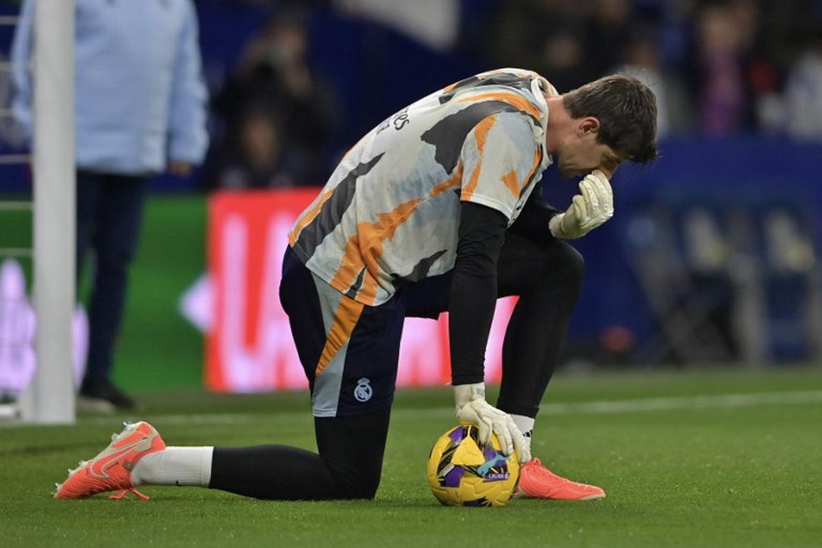 Real Madrid's Belgian goalkeeper #01 Thibaut Courtois warms up before the Spanish league football match between RCD Espanyol and Real Madrid CF at the RCDE Stadium in Cornella de Llobregat on February 1, 2025.  MANAURE QUINTERO / AFP