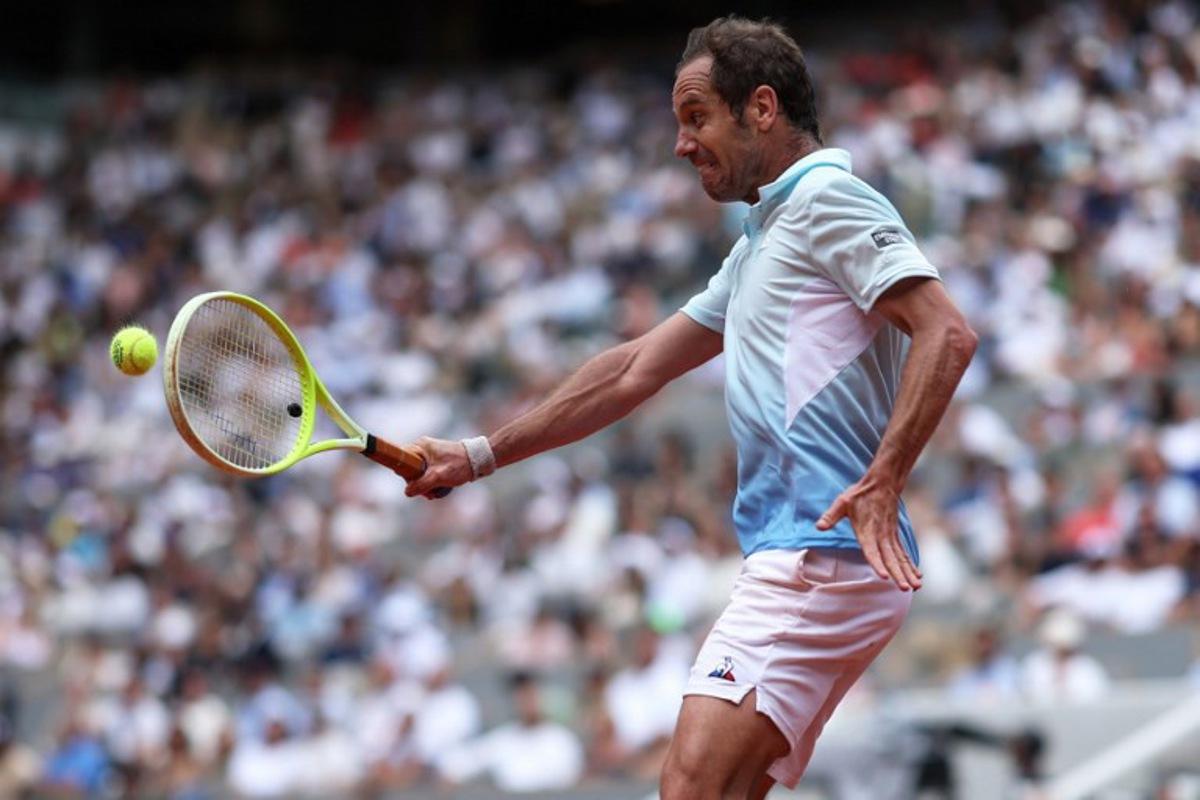 France's Richard Gasquet plays a backhand return to Italy's Jannik Sinner during their men's singles match on day 5 of the French Open tennis tournament on Court Philippe-Chatrier at the Roland-Garros Complex in Paris on May 29, 2025.  ALAIN JOCARD / AFP