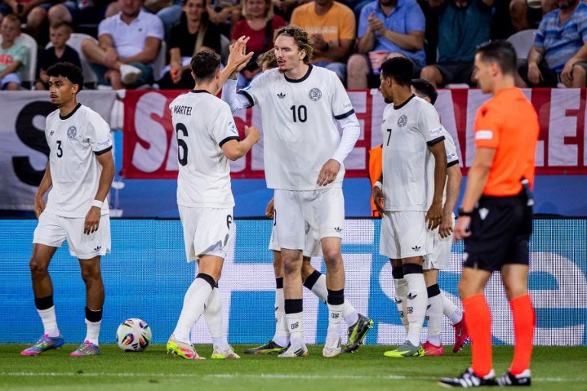 Germany's forward #10 Nick Woltemade (C), Germany's midfielder #06 Eric Martel (2nd L) and teammates celebrate after Germany scored a goal during the UEFA U21 European Championship semi-final football match between Germany and France in Kosice, Slovakia on June 25, 2025.  Branislav Racko / AFP