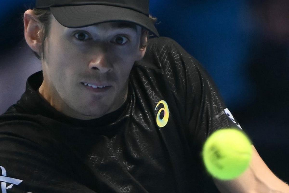 Australia's Alex De Minaur hits the ball during his match against USA's Taylor Fritz at the ATP Finals tennis tournament in Turin on November 13, 2025.  Marco BERTORELLO / AFP