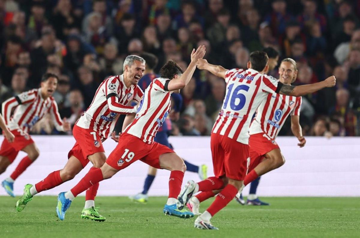 Atletico Madrid's Argentine forward #19 Julian Alvarez (R) celebrates scoring his team's first goal with teammates during the UEFA Champions League quarter final first leg football match between FC Barcelona and Club Atletico de Madrid at Camp Nou Stadium in Barcelona on April 8, 2026.  Josep LAGO / AFP