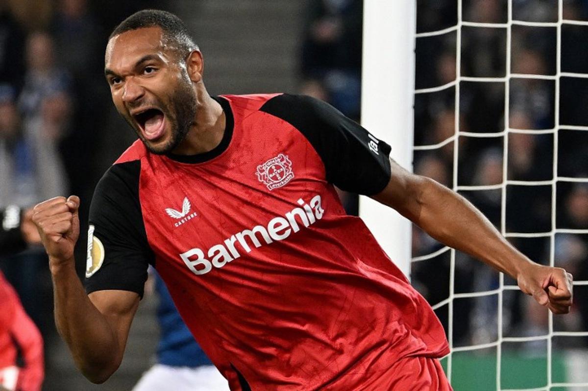 Bayer Leverkusen's German defender #04 Jonathan Tah celebrates scoring the opening goal with his teammates during the German Cup (DFB Pokal) semi-final football match between Arminia Bielefeld and Bayer 04 Leverkusen in Bielefeld, western Germany on April 1, 2025.  UWE KRAFT / AFP