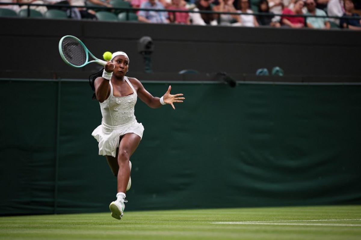 US player Coco Gauff plays a forehand return to Ukraine's Dayana Yastremska during their women's singles first round tennis match on the second day of the 2025 Wimbledon Championships at The All England Lawn Tennis and Croquet Club in Wimbledon, southwest London, on July 1, 2025.  HENRY NICHOLLS / AFP