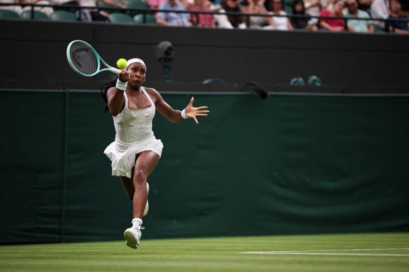 US player Coco Gauff plays a forehand return to Ukraine's Dayana Yastremska during their women's singles first round tennis match on the second day of the 2025 Wimbledon Championships at The All England Lawn Tennis and Croquet Club in Wimbledon, southwest London, on July 1, 2025.  HENRY NICHOLLS / AFP