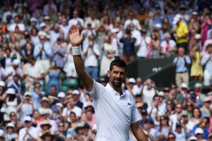 Serbia's Novak Djokovic greets the audience after winning his men's singles second round tennis match against Britain's Daniel Evans on the fourth day of the 2025 Wimbledon Championships at The All England Lawn Tennis and Croquet Club in Wimbledon, southwest London, on July 3, 2025.  Adrian Dennis / AFP