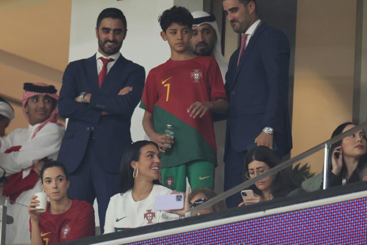 Portugal's forward #07 Cristiano Ronaldo's partner Georgina Rodriguez (bottom) and son Cristiano Ronaldo Jr (C) attend the Qatar 2022 World Cup quarter-final football match between Morocco and Portugal at the Al-Thumama Stadium in Doha on December 10, 2022.  KARIM JAAFAR / AFP