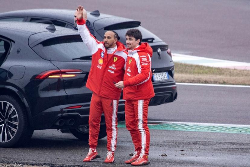 Ferrari's British driver Lewis Hamilton (L) and Ferrari's Monegasque driver Charles Leclerc wave to fans after testing the new Formula 1 Ferrari SF-26 at Fiorano Circuit in Fiorano Modenese on January 23, 2026.  Federico SCOPPA / AFP
