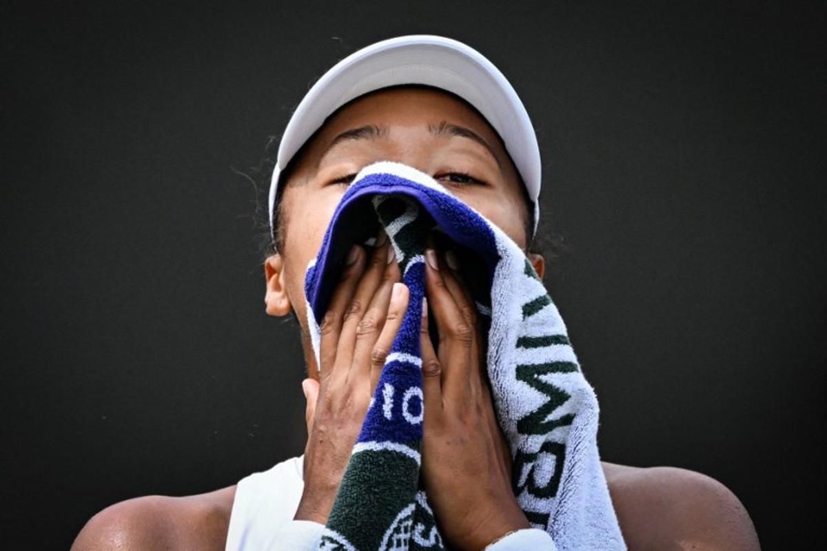 Japan's Naomi Osaka wipes her face with a towel as she plays against Russia's Anastasia Pavlyuchenkova during their women's singles third round tennis match on the fifth day of the 2025 Wimbledon Championships at The All England Lawn Tennis and Croquet Club in Wimbledon, southwest London, on July 4, 2025.  Kirill KUDRYAVTSEV / AFP