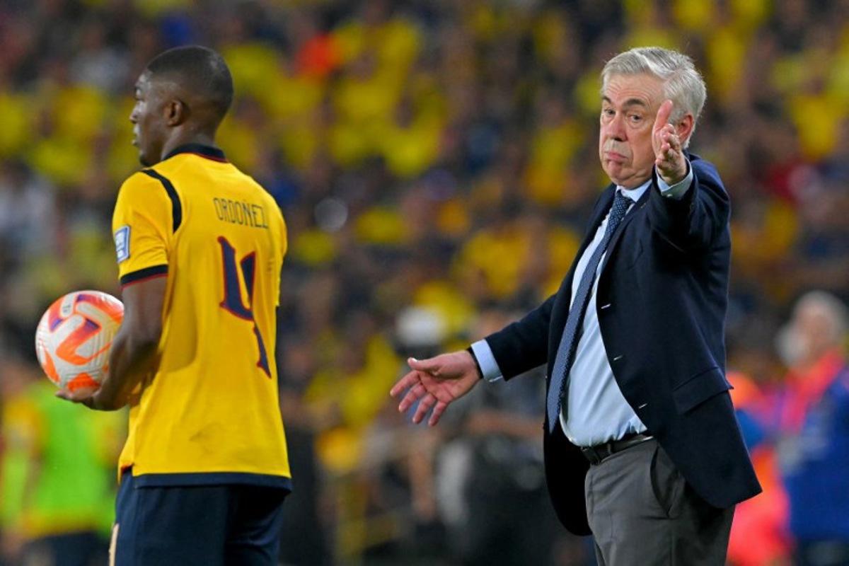 Brazil's Italian head coach Carlo Ancelotti gestures past Ecuador's defender #04 Joel Ordonez during the 2026 FIFA World Cup South American qualifiers football match between Ecuador and Brazil at the Monumental Banco Pichincha stadium in Guayaquil, province of Guayas, Ecuador on June 5, 2025.   Rodrigo BUENDIA / AFP