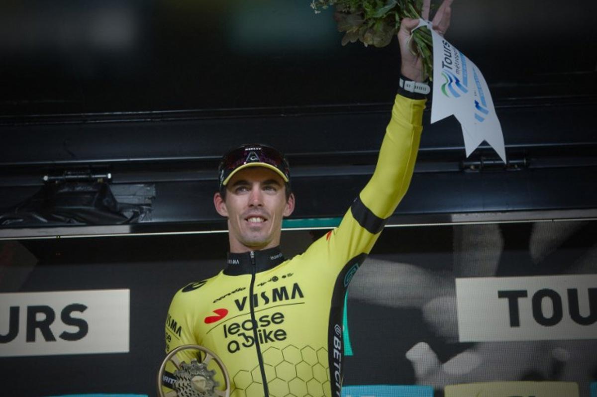French rider of team Visma Lease A Bike Christophe Laporte celebrates on the podium after he won the 118th edition of the 213,9 km Paris-Tours one day cycling race, in Tours, central France on October 6, 2024.  GUILLAUME SOUVANT / AFP