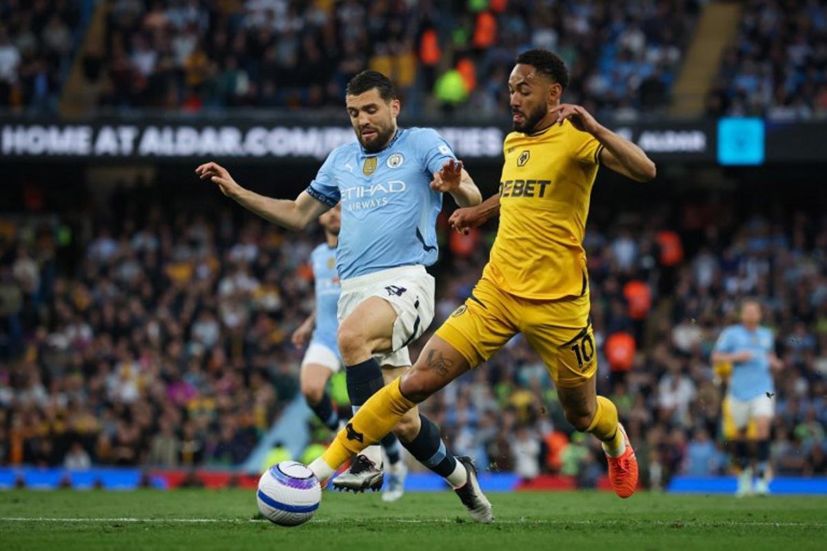 Manchester City's Croatian midfielder #08 Mateo Kovacic (L) fights for the ball with Wolverhampton Wanderers' Brazilian striker #10 Matheus Cunha (R) during the English Premier League football match between Manchester City and Wolverhampton Wanderers at the Etihad Stadium in Manchester, north west England, on May 2, 2025.  Darren Staples / AFP