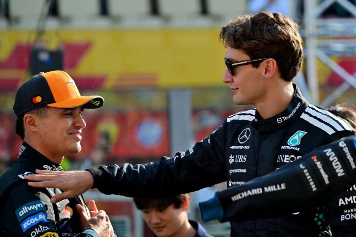 McLaren's British driver Lando Norris and Mercedes' British driver George Russell chat ahead of the Abu Dhabi Formula One Grand Prix at the Yas Marina Circuit in Abu Dhabi on December 7, 2025.  Andrej ISAKOVIC / AFP