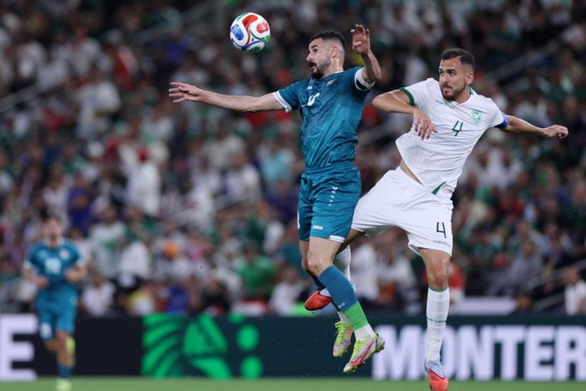 Iraq's forward #18 Aymen Hussein and Bolivia's defender #04 Luis Haquin fight for the ball during the 2026 FIFA World Cup qualifiers final playoff football match between Iraq and Bolivia at the BBVA Stadium in Guadalupe, Nuevo Leon state, Mexico, on March 31, 2026.  Julio Cesar AGUILAR / AFP