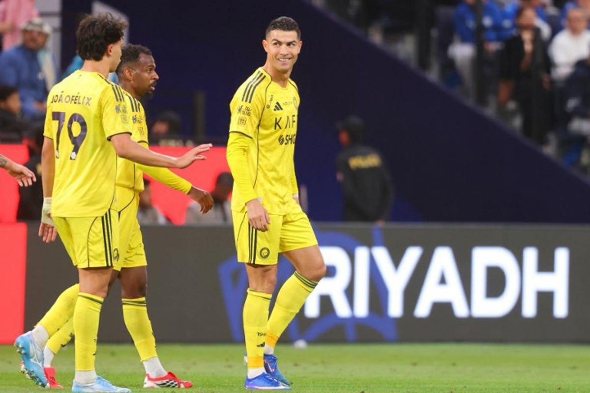 Nassr's Portuguese forward #07 Cristiano Ronaldo (R) celebrates with his teammates after scoring a goal during the Saudi Pro League football match between Al-Hilal and Al-Nassr at Kingdom Arena stadium in Riyadh on January 12, 2026.  Fayez Nureldine / AFP
