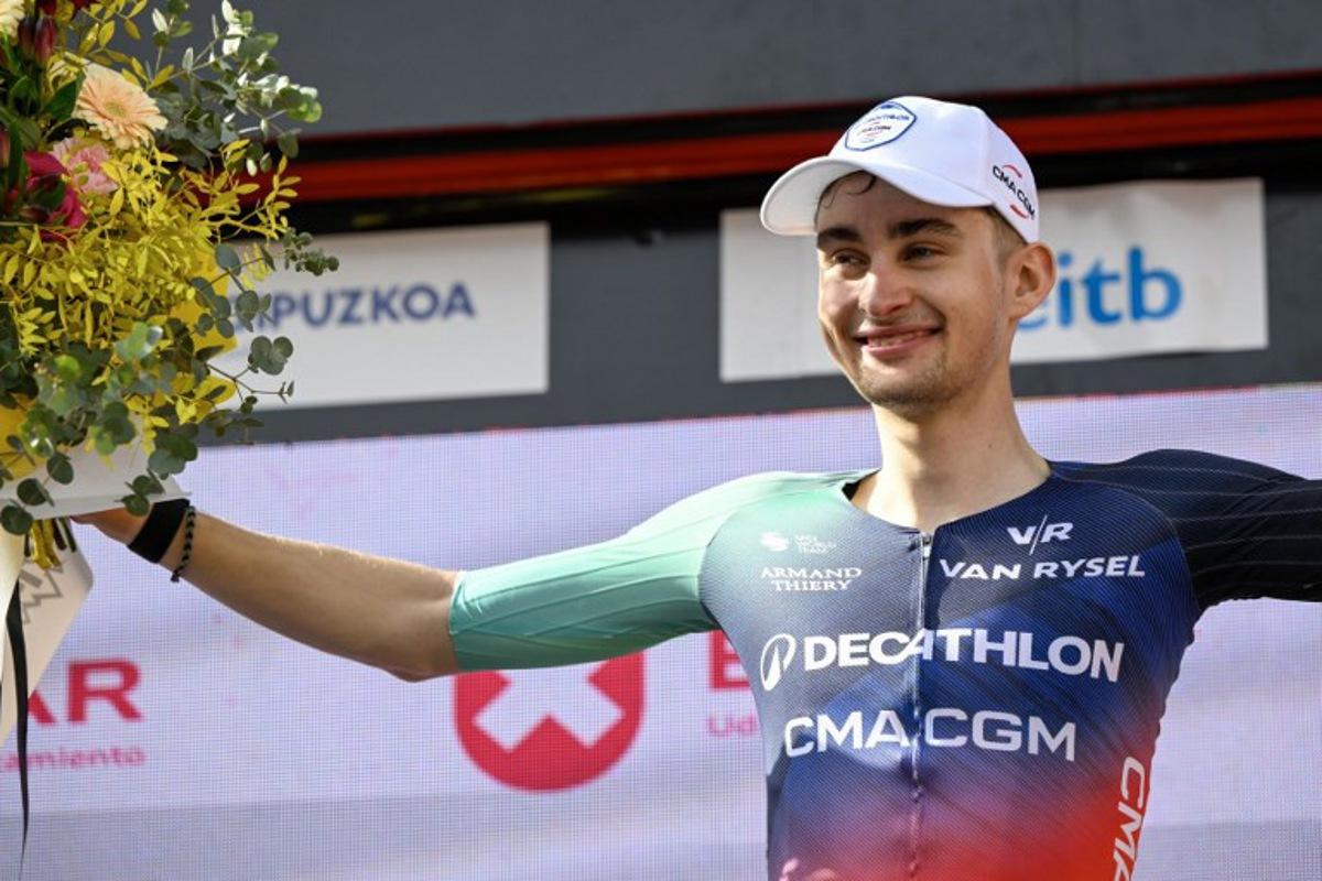 Team Decathlon CMA CGM's French rider Paul Seixas celebrates on the podium after winning the fifth stage of the Basque Country's Itzulia cycling tour, a 176.2 km race starting and finishing in Eibar, on April 10, 2026.  Seixas is the overall race leader. ANDER GILLENEA / AFP