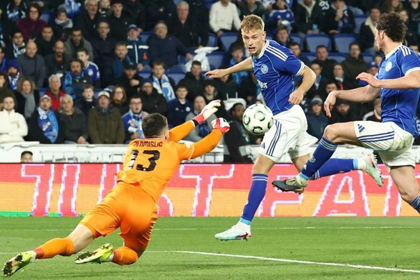 Strasbourg's Danish defender #24 Lucas Hogsberg (R) fights for the ball with Rijeka's Bosnian goalkeeper #13 Martin Zlomislic during the UEFA Europa Conference League last 16 second leg football match between RC Strasbourg Alsace and Rijeka at the Stade de la Meinau in Strasbourg, eastern France, on March 19, 2026.  Frederick FLORIN / AFP