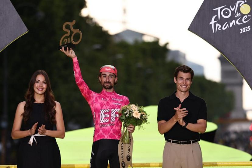 EF Education - EasyPost team's Irish rider Ben Healy celebrates on the podium with the most combative rider's award after the 21st and final stage of the 112th edition of the Tour de France cycling race, 132.3 km between Mantes-la-Ville and Paris Champs-Élysees, on July 27, 2025.  Anne-Christine POUJOULAT / AFP