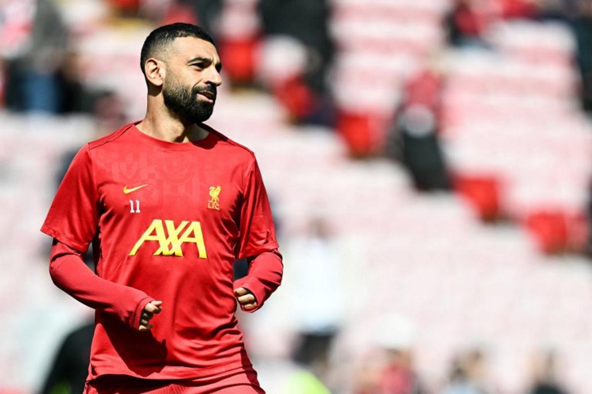 Liverpool's Egyptian striker #11 Mohamed Salah reacts as he warms up prior to the English Premier League football match between Liverpool and West Ham United at Anfield in Liverpool, north west England on April 13, 2025.  Paul ELLIS / AFP