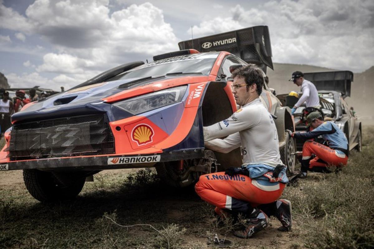 Hyundai Shell Mobis World Rally Team's Belgian driver and current World Champion Thierry Neuville works on his Hyundai i20 N Rally1 ahead of the final special stage of the World Rally Championship (WRC) Safari Rally Kenya in Naivasha on March 23, 2025.  Luis TATO / AFP