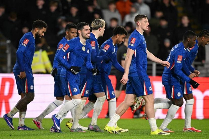 Chelsea's Portuguese midfielder #07 Pedro Neto (3L) smiles as Chelsea players celebrate their second goal scored direct from the corner take by Neto during the English FA Cup fourth round football match between Hull City and Chelsea at the MKM  Stadium in Kingston upon Hull, north east England on February 13, 2026.  Oli SCARFF / AFP
