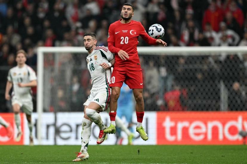 Hungary's midfielder #18 Zsolt Nagy and Turkey's forward #20 Oguz Aydin jump for the ball during the UEFA Nations League playoff first-leg football match between Turkey and Hungary at the Rams Park Ali Samiyen Sport Complex Stadium in Istanbul on March 20, 2025.  OZAN KOSE / AFP