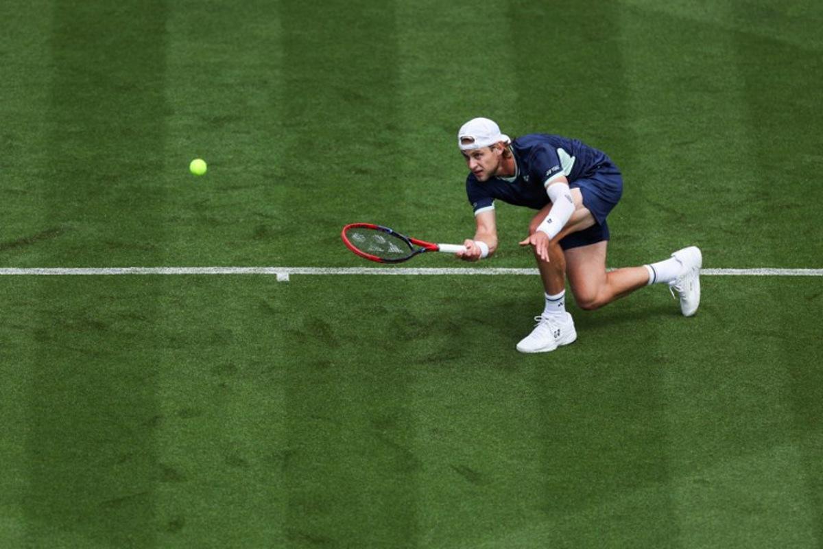 Belgium's Zizou Bergs plays a forehand return to Brazil's Joao Fonseca during their men's singles tennis match on day one at the Rothesay Eastbourne International tennis tournament in Eastbourne, southern England, on June 23, 2025.  Adrian Dennis / AFP