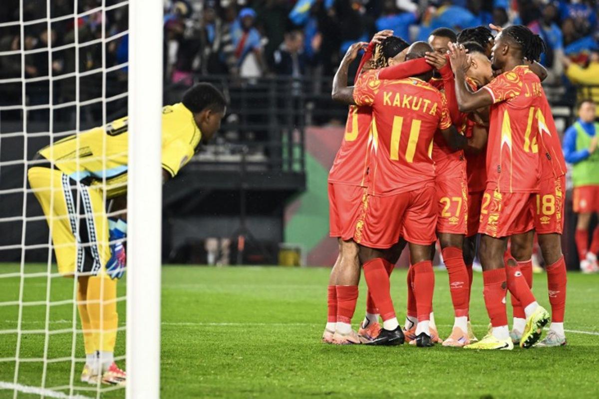 Democratic Republic Of Congo's midfielder #11 Mario Stroeykens is congratulated by teammates after scoring a goal during the Africa Cup of Nations (CAN) Group D football match between Botswana and Democratic Republic of Congo at El Madina Stadium in Rabat on December 30, 2025.   SEBASTIEN BOZON / AFP