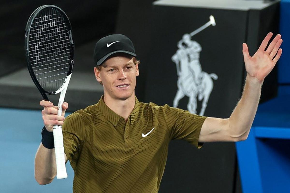 Italy's Jannik Sinner celebrates after winning against Australia's James Duckworth during their men's singles match on day five of the Australian Open tennis tournament in Melbourne on January 22, 2026.  IZHAR KHAN / AFP