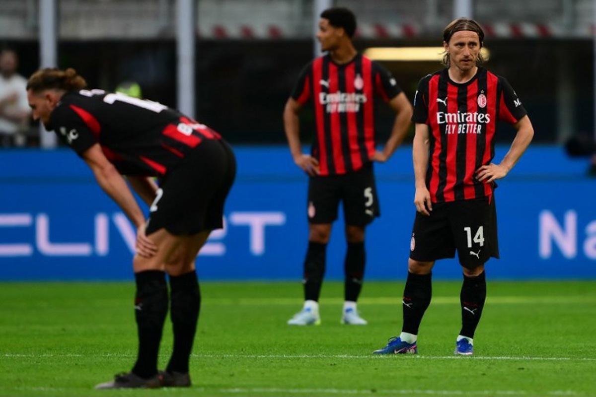 AC Milan Croatian midfielder #14 Luka Modrić (R) reacts during the Italian Serie A football match between AC Milan and Udinese at the San Siro stadium in Milan, northern Italy, on April 11, 2026.  MARCO BERTORELLO / AFP