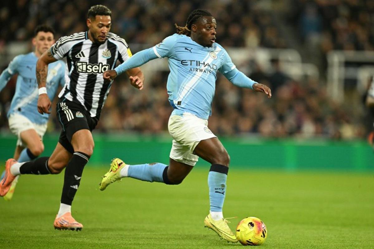 Manchester City's Belgian midfielder #11 Jeremy Doku runs with the ball during the English Premier League football match between Newcastle United and Manchester City at St James' Park in Newcastle-upon-Tyne, north east England on November 22, 2025.  Oli SCARFF / AFP