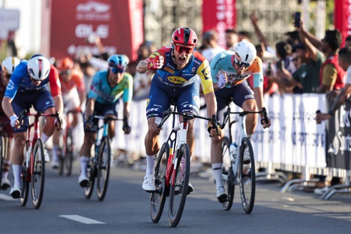 Lidl-Trek's Italian rider Jonathan Milan reacts after crossing the finish line first during the fourth stage of the UAE Tour cycling event in al-Fujairah on February 19, 2026.  Fadel SENNA / AFP