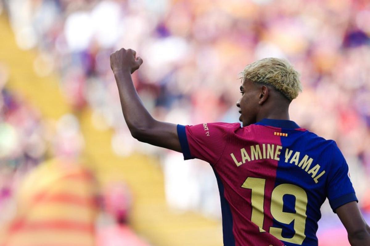 Barcelona's Spanish forward #19 Lamine Yamal celebrates scoring his team's second goal during the Spanish league football match between FC Barcelona and Real Madrid CF at Estadi Olimpic Lluis Companys in Barcelona, on May 11, 2025.  LLUIS GENE / AFP