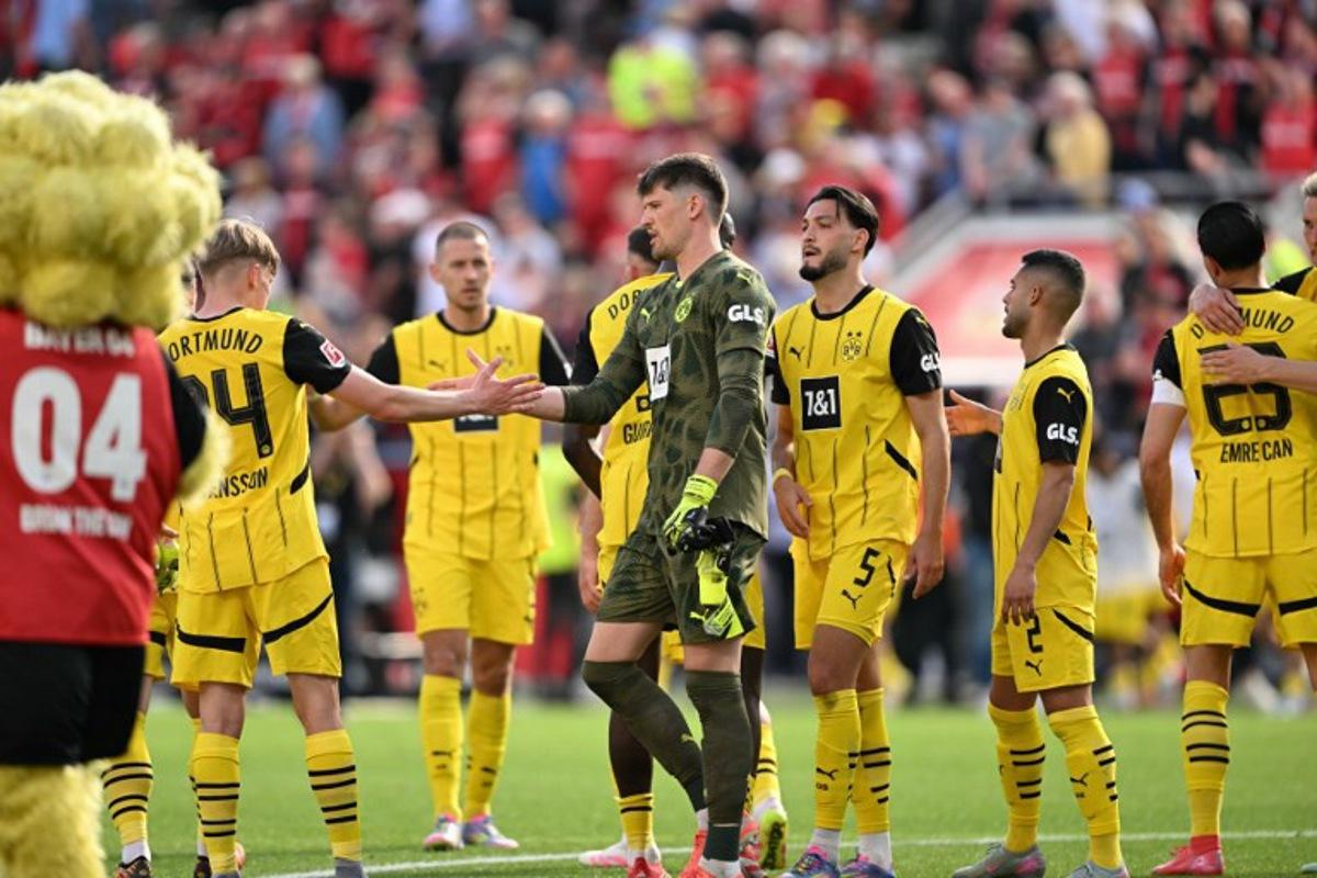Dortmund's team react after the German first division Bundesliga football match between Bayer 04 Leverkusen and Borussia Dortmund in Leverkusen, western Germany, on May 11, 2025.  INA FASSBENDER / AFP