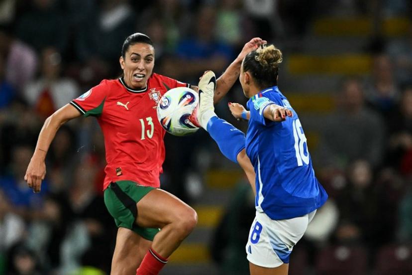 Portugal's midfielder #13 Fatima Pinto (L) and Italy's midfielder #18 Arianna Caruso (R) fight for the ball during the UEFA Women's Euro 2025 Group B football match between Portugal and Italy at the Stade de Geneve in Geneva, on July 7, 2025.  Fabrice COFFRINI / AFP