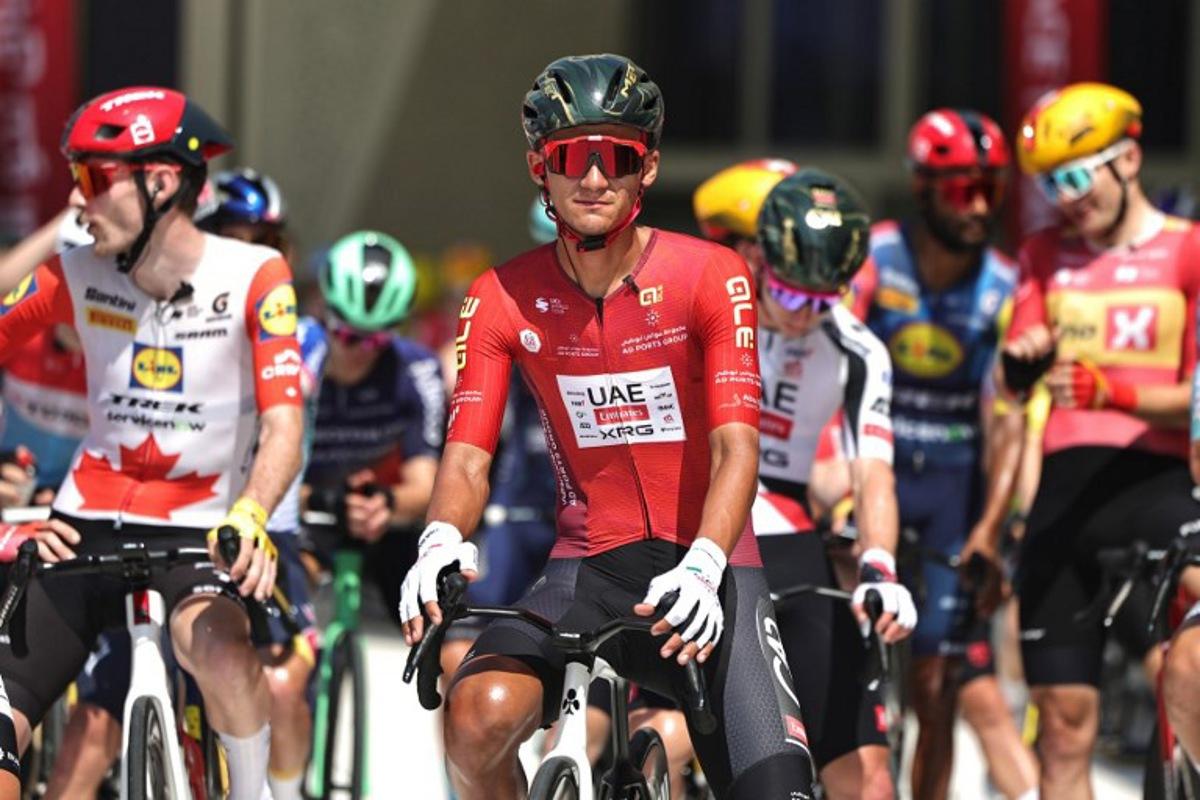 UAE Team Emirates's Mexican rider Isaac Del Toro Romero and other riders wait at the start line of the seventh and final stage of the UAE Tour cycling event from Zayed National Museum to Abu Dhabi Breakwater in Abu Dhabi on February 22, 2026.  Fadel SENNA / AFP