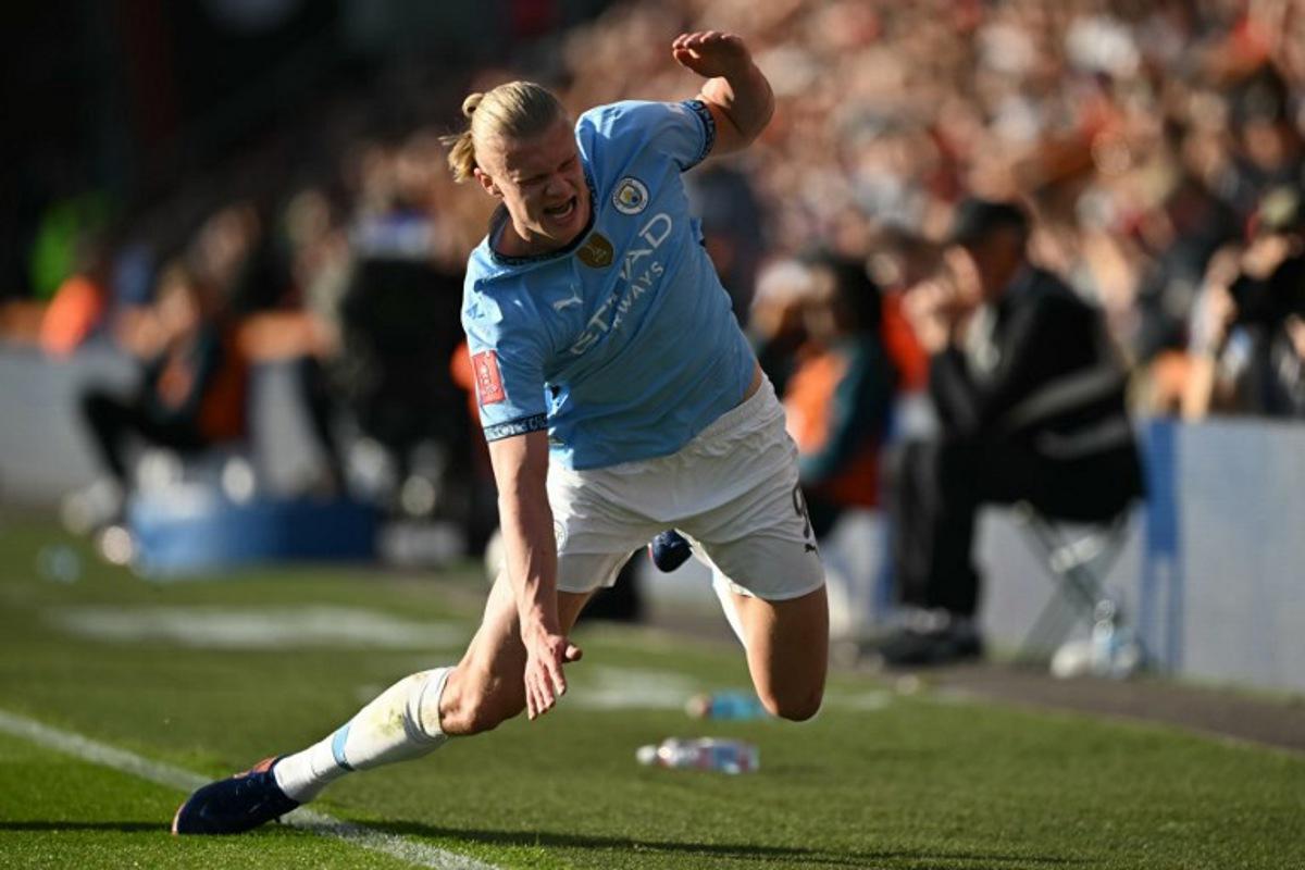 Manchester City's Norwegian striker #09 Erling Haaland reacts after a challenge with Bournemouth's English midfielder #04 Lewis Cook during the English FA Cup quarter-final football match between Bournemouth and Manchester City at the Vitality Stadium in Bournemouth, on the south coast of England on March 30, 2025.  JUSTIN TALLIS / AFP