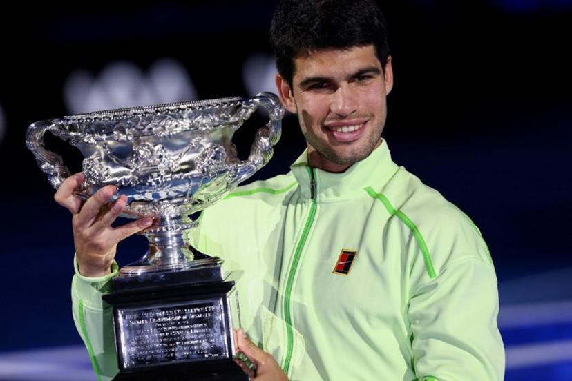 Spain's Carlos Alcaraz poses with the Norman Brookes Challenge Cup after winning against Serbia's Novak Djokovic in their men's singles final match on day fifteen of the Australian Open tennis tournament in Melbourne on February 1, 2026.  IZHAR KHAN / AFP