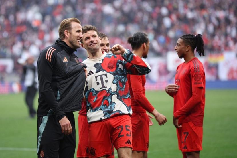 Bayern Munich's German forward #25 Thomas Mueller (2L) and Bayern Munich's English forward #09 Harry Kane talk after the German first division Bundesliga football match between RB Leipzig and FC Bayern Munich in Leipzig, eastern Germany on May 3, 2025.  Ronny HARTMANN / AFP