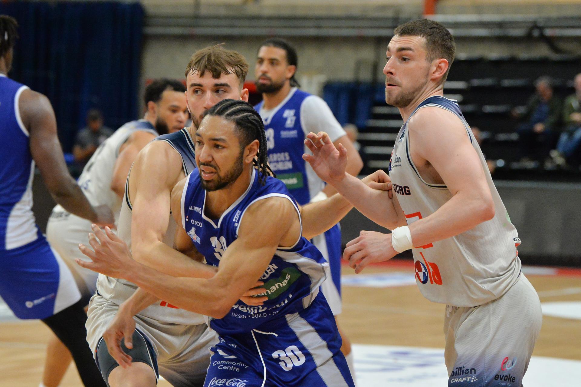 Limburg's Wout Leemans, Mechelen's Joshua Heath and Limburg's Jarne Lesuisse pictured in action during a basketball match between Limburg United and Kangoeroes Mechelen, Thursday 22 May 2025 in Hasselt, the second leg of the best-of-5 semi-finals in the playoffs of the 'BNXT League' Belgian/ Dutch first division basket championship. BELGA PHOTO JILL DELSAUX
