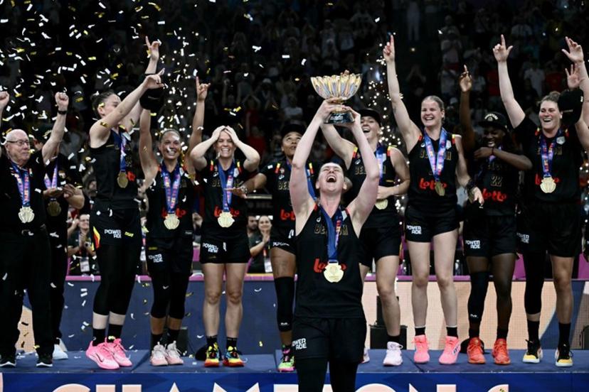 Belgium's power forward Emma Meesseman (C) holds the trophy and celebrates with teammates winning the 2025 FIBA Women's EuroBasket after their final match against Spain at the Peace and Friendship Stadium in Athens on June 29, 2025.  Aris MESSINIS / AFP