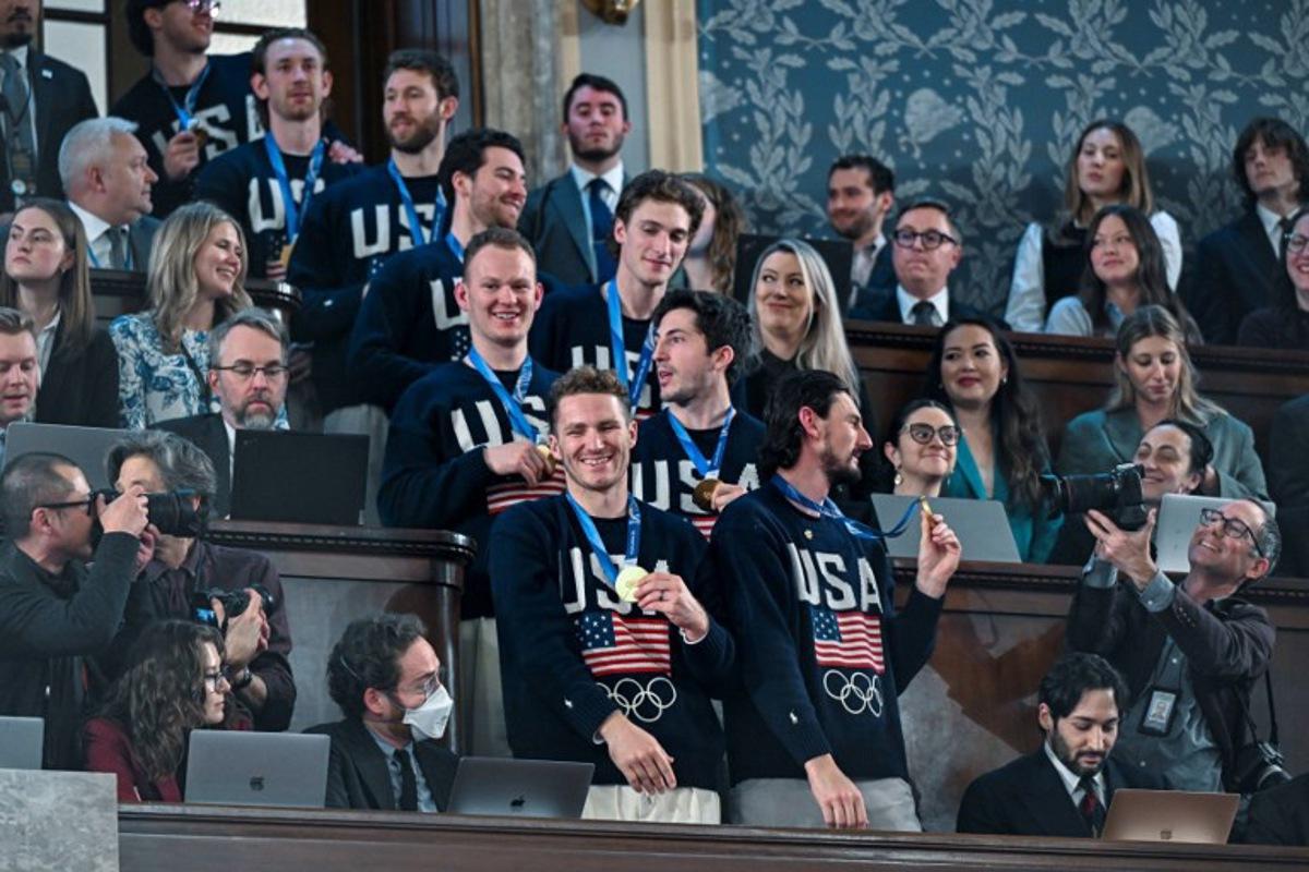 Members of the United States Olympic Men's Ice Hockey Teamare seen in the gallery as President Donald J. Trump delivers the first State of the Union address of his second term to a joint session of Congress in the House Chamber of the United States Capitol in Washington, DC, on February 24, 2026.  Kenny HOLSTON / POOL / AFP