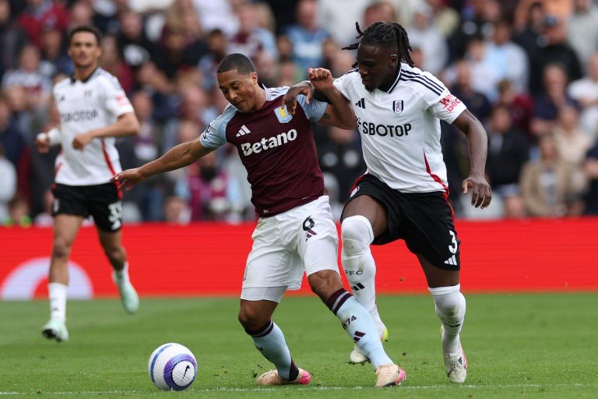 Aston Villa's Belgian midfielder #08 Youri Tielemans (C) is fouled by Fulham's Italian-born Nigerian defender #03 Calvin Bassey (R) during the English Premier League football match between Aston Villa and Fulham at Villa Park in Birmingham, central England on May 3, 2025.  Adrian Dennis / AFP