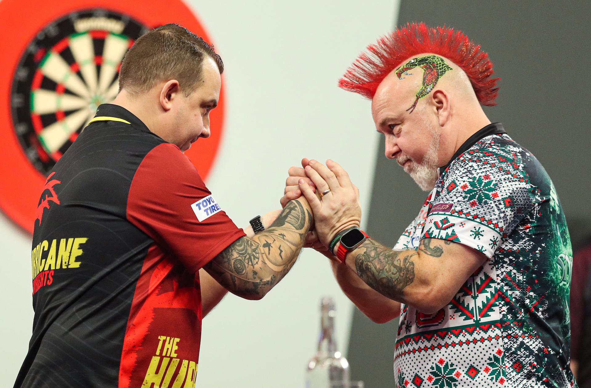 ATTENTION EDITORS - HAND OUT PICTURES - EDITORIAL USE WITH STORY ON DARTS WORLD CHAMPIONSHIPS ONLY - MANDATORY CREDIT KIERAN CLEEVES/PDC  Hand out pictures released by PDC Professional Darts Corporation shows  Scottish Peter Wright (R) congratulating Belgian Kim Huybrechts with his victory on day ten of the 2023 Cazoo World Darts Championship at Alexandra Palace, London, UK, on Tuesday 27 December 2022. MANDATORY CREDIT KIERAN CLEEVES/PDC