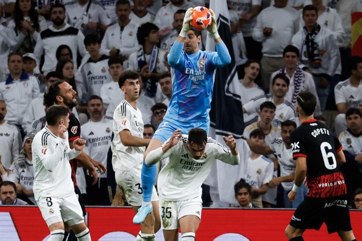 Real Madrid's Belgian goalkeeper #01 Thibaut Courtois (C) makes a save during the Spanish league football match between Real Madrid CF and RCD Mallorca at the Santiago Bernabeu Stadium in Madrid, on May 14, 2025.  Pierre-Philippe MARCOU / AFP