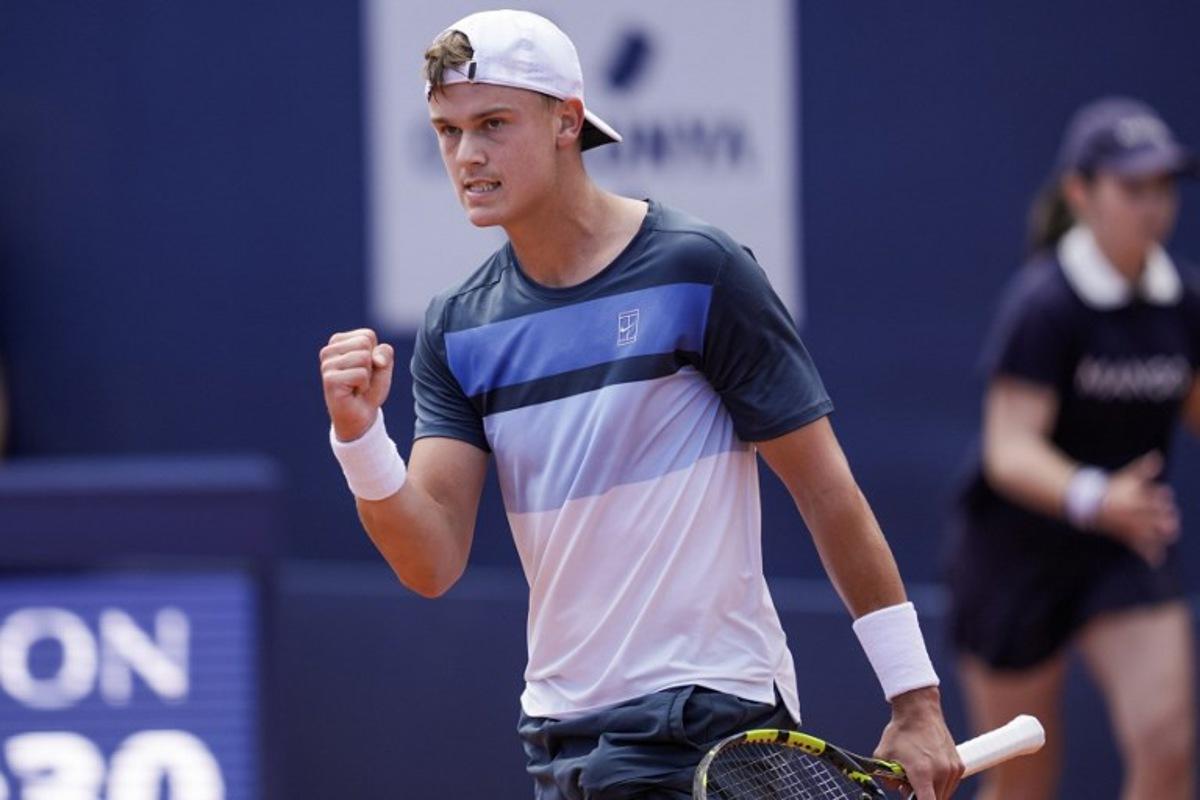 Denmark's Holger Rune reacts after winning a point against Spain's Carlos Alcaraz during the ATP Barcelona Open "Conde de Godo" tennis tournament singles final match at the Real Club de Tenis in Barcelona, on April 20, 2025.  MANAURE QUINTERO / AFP