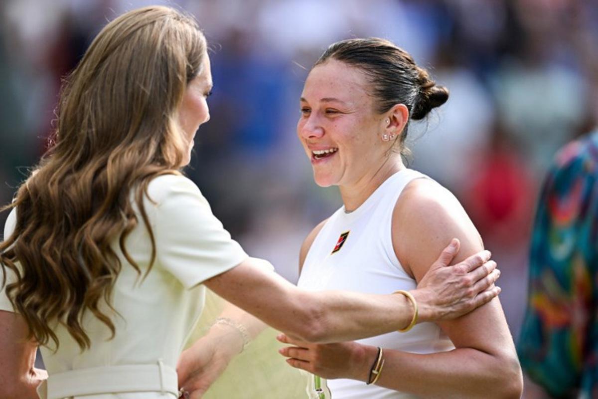 Britain's Catherine, Princess of Wales (L) comforts as she gives the runner up trophy, to US player Amanda Anisimova after her defeat against Poland's Iga Swiatek at the end of their women's singles final tennis match on the thirteenth day of the 2025 Wimbledon Championships at The All England Lawn Tennis and Croquet Club in Wimbledon, southwest London, on July 12, 2025.  Kirill KUDRYAVTSEV / AFP
