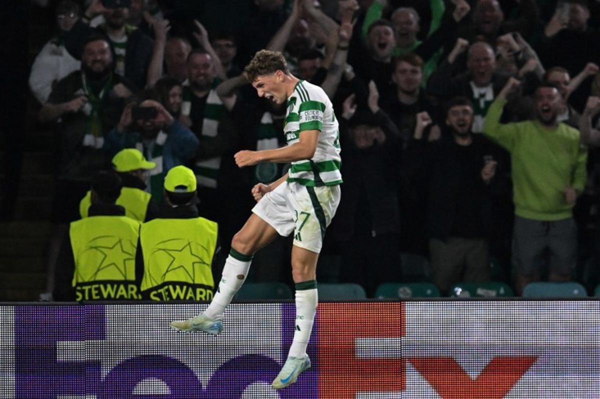 Celtic's Belgian midfielder #27 Arne Engels celebrates after scoring a penalty and his teams third goal during the UEFA Champions League, league phase football match between Celtic and Slovan Bratislava at Celtic Park stadium in Glasgow on September 18, 2024.  ANDY BUCHANAN / AFP
